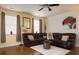 Living room with brown leather sectional sofa, ceiling fan, and hardwood floors at 131 Tin Can Aly, Summerville, SC 29483
