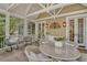 Relaxing screened porch with seating area and glass-top table, perfect for outdoor dining at 512 Whilden St, Mount Pleasant, SC 29464