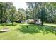 Mobile home with a large yard and surrounding trees at 121 Paisan Rd, Summerville, SC 29483