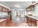 Open kitchen with dark wood cabinets, stainless steel appliances, and wood flooring at 121 Paisan Rd, Summerville, SC 29483