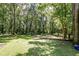 Wooded backyard with a wooden walkway and garden at 121 Paisan Rd, Summerville, SC 29483