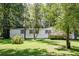Mobile home with a deck and mature trees at 121 Paisan Rd, Summerville, SC 29483