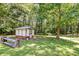 Rustic backyard shed nestled amongst mature trees at 121 Paisan Rd, Summerville, SC 29483