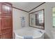 Corner bathtub and dark wood cabinets in this clean bathroom at 121 Paisan Rd, Summerville, SC 29483