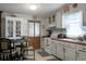 Kitchen features white cabinets, an eat-in area, and access to another room at 2363 Ranger Dr, Cross, SC 29436