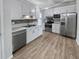 Modern kitchen featuring stainless steel appliances and white cabinets at 1990 Central Ave, Summerville, SC 29483