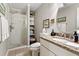 Modern bathroom with granite countertop vanity, glass shower, and shelving at 302 Summerset Ln, Summerville, SC 29483