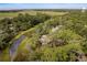 Aerial view of a home nestled in a quiet, tree-lined neighborhood near the water at 2963 Deer Point Dr, Seabrook Island, SC 29455