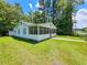 Front view of a cozy one-story house featuring a screened porch at 212 Hickory St, Walterboro, SC 29488