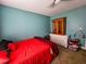 Bedroom with red bedding and wooden cabinet at 212 Hickory St, Walterboro, SC 29488