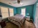 Spacious bedroom with teal walls, ceiling fan, and a queen bed at 212 Hickory St, Walterboro, SC 29488