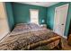 Well-lit bedroom with teal walls and a full-size bed at 212 Hickory St, Walterboro, SC 29488
