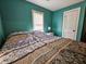 Cozy bedroom with teal walls, one window, and a full-size bed at 212 Hickory St, Walterboro, SC 29488