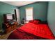 Cozy bedroom with red bedding and a window at 212 Hickory St, Walterboro, SC 29488