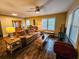 Bright living room with hardwood floors, comfortable seating, and large windows at 212 Hickory St, Walterboro, SC 29488