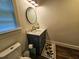 Modern bathroom with vanity, round mirror, and wood-look floors at 212 Hickory St, Walterboro, SC 29488
