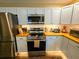 Updated kitchen with stainless steel appliances and wood countertops at 212 Hickory St, Walterboro, SC 29488