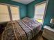 Bright bedroom with teal walls and a full-size bed at 212 Hickory St, Walterboro, SC 29488