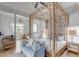 Bright bedroom featuring a large canopy bed and a cozy sitting area at 3025 Southerly Way, Johns Island, SC 29455