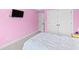 Pink bedroom with white comforter, double doors leading to the closet, and a TV at 1104 Beresford Run, Charleston, SC 29492