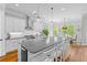 Modern kitchen featuring white cabinets, large island, and stainless steel appliances at 1104 Beresford Run, Charleston, SC 29492