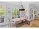 Bright breakfast nook with farmhouse table, bench seating, and access to deck at 1104 Beresford Run, Charleston, SC 29492