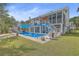 Backyard oasis with a pool, spacious deck, and screened porch at 1374 Black River Dr, Mount Pleasant, SC 29466