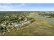 Aerial view showing waterfront homes, boat docks, and marshy landscape at 1374 Black River Dr, Mount Pleasant, SC 29466