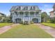 Two-story house with light blue exterior, white trim, and a double garage at 1374 Black River Dr, Mount Pleasant, SC 29466