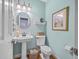 Light and airy powder room with pedestal sink and framed art at 1374 Black River Dr, Mount Pleasant, SC 29466