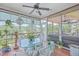 Relaxing screened porch with glass table and wicker chairs, offering serene water views at 1374 Black River Dr, Mount Pleasant, SC 29466