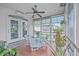 Relaxing screened porch with seating area and wood flooring at 1374 Black River Dr, Mount Pleasant, SC 29466