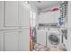Bright laundry room with washer, dryer, and ample cabinet space at 1374 Black River Dr, Mount Pleasant, SC 29466