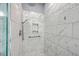 Walk-in shower with marble tile and glass enclosure at 1374 Black River Dr, Mount Pleasant, SC 29466