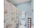 Small bathroom with toilet, shower, and seashell-themed curtain at 1374 Black River Dr, Mount Pleasant, SC 29466