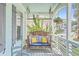 Relaxing front porch with a wooden swing and comfy cushions at 1374 Black River Dr, Mount Pleasant, SC 29466