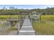 Private boat dock with a covered gazebo and a small motorboat at 1374 Black River Dr, Mount Pleasant, SC 29466