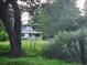 A damaged house exterior with overgrown yard at 1132 Brownswood Rd, Johns Island, SC 29455