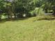 Spacious grassy yard with mature trees and shrubs at 1132 Brownswood Rd, Johns Island, SC 29455