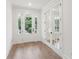 Light-filled entryway with hardwood floors and white French doors at 1631 Siloh Siloh Dr # 482, Mount Pleasant, SC 29466