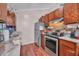 Galley kitchen with wood cabinets, stainless steel appliances, and laminate countertops at 3264 Heaton Dr, Ladson, SC 29456