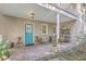 Charming brick patio with teal door and seating area at 11 George St # Abcd, Charleston, SC 29401