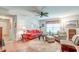 Cozy living room featuring a red couch, wooden floors, and a ceiling fan at 156 Keaton Brook Dr, Summerville, SC 29485