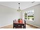 Bright dining room with red table and four chairs, large window with a view at 9064 Maple Grove Dr, Summerville, SC 29485