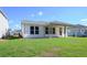 View of the backyard showing a covered patio and white siding on the house at 615 Coral Bells Ln, Summerville, SC 29486