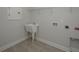 Laundry room with utility sink, gray tile floor, and hookups for washer and dryer at 615 Coral Bells Ln, Summerville, SC 29486