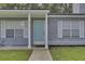 Gray house exterior with a light blue front door and white shutters at 9510 Raven Dr, Ladson, SC 29456