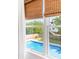 View of refreshing blue swimming pool from bedroom window at 512 Carolina Blvd, Isle of Palms, SC 29451