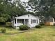 Charming one-story home with white siding and maroon shutters at 1032 Greenhill Rd, Charleston, SC 29412