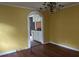 Bright dining room with hardwood floors and an arched pass-through to the kitchen at 1032 Greenhill Rd, Charleston, SC 29412